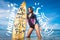attractive young woman in wetsuit with surfboard posing in ocean at Nusa dua Beach Bali Indonesia