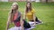 Attractive young women performs training for flexibility in the park