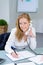 Attraktive woman in office at telephone writting