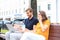 Attrative young couple using laptop computer while sitting on a bench outdoors