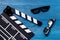 Attributes of film director. Movie clapperboard and sunglasses on blue wooden table background top view