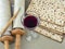 Attributes of Jewish pasch: a glass of red wine, Torah scrolls and matzoh on a gray canvas.