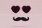 attributes for photos. black heart-shaped glasses and a black mustache on a pastel background. 3D render