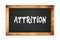 ATTRITION text written on wooden frame school blackboard