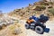 ATV quad bikes parked on a rocky mountain slope