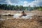 Atv rider in muddy water. Xtreme utv ride