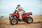 An atv rider racing in desert