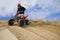 ATV rider spray sand in dunes