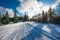 ATV and ski tracks in snow on frosty winter day