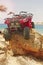 ATVs on rock on beach of sea