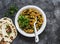 Aubergine spinach vegetarian curry with naan flatbread on a dark background, top view. Indian cuisine