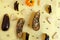 Aubergines with cheese and chili peppers in a pattern on yellow artistic wooden background