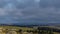 Aubrac, France - Timelapse - Cloudy Sky at Day Over a Wide and Desert Lowland in France Some Rocks in the Ground