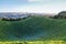 Auckland city skyline beyond frosty crater of Mount Eden