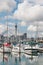 Auckland marina with yachts, sail ships and Sky Tower in background