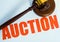 Auction sign and mallet on a white background