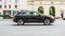 Audi Q8 car driving in city with motion blur, view from the side