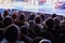 The audience in the theater watching a play. The audience in the hall: adults and children