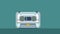 Audio cassette tape playing animation over green background with copyspace.