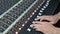 Audio mixing board, adjusting faders