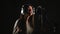 Audio recording studio. Woman with headphones and studio microphone singing.