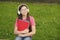 Audio to rock your life. Small child listen to music on green grass. Little girl wear audio headphones. Listening to