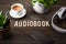 Audiobook word text concept modern wireless headphones smartphone