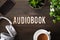 Audiobook word text concept modern wireless headphones smartphone