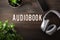 Audiobook word text concept modern wireless headphones smartphone