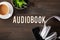 Audiobook word text concept modern wireless headphones smartphone