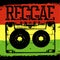 Audiocassette and Reggae lettering. Vector reggae design with audiocassette on rastafarian grunge background