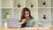 Auditor woman holding magnifying glass examining the numerical data on financial document