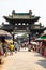 Aug 2013 - Pingyao, Shanxi, China - tourists walk under a carved archway in one of the main streets of Pingyao ancient city.