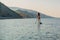 August 06, 2022. Dalaman, Turkey. Beauty young woman rowing on stand up paddle board at sea