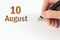 August 10th. Day 10 of month, Calendar date. The hand holds a black pen and writes the calendar date. Summer month, day of the