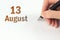 August 13rd. Day 13 of month, Calendar date. The hand holds a black pen and writes the calendar date. Summer month, day of the