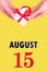 August 15th. Festive Vertical Calendar With Hands Holding White Gift Box With Red Ribbon And Calendar Date