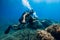 August 20, 2020. Anapa, Russia. Couple of scuba divers glides underwater in transparent blue sea. Scuba diving in clear ocean