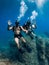 August 20, 2020. Anapa, Russia. Couple of scuba divers glides underwater in transparent blue sea. Scuba diving in clear ocean