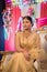 August 2019, Kolkata, India: Portrait of an Indian bride standing with glamorous outfit and jewellery with makeup in a banquet