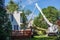 August, 2020: A truck with a large crane being used by a tree service to remove a tree that fell on the roof of a house during a