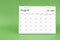 August 2024 desk calendar isolated in green background
