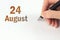 August 24th. Day 24 of month, Calendar date. The hand holds a black pen and writes the calendar date. Summer month, day of the