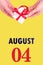 August 4th. Festive Vertical Calendar With Hands Holding White Gift Box With Red Ribbon And Calendar Date