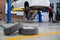 Auomobile repair, Used car tires on epoxy floor in auto workshop, Vehicle raised on lift at maintenance station. Check the