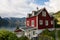 AURLAND, NORWAY - AUGUST 2017: Tradional red wooden house standing on the shore of Aurlandsfjord, Norway