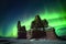 aurora borealis above a desert rock formation at night