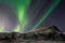 Aurora Borealis above mountain hill. Captured near Skibon, Norway