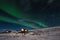 Aurora Borealis with cottage houses in winter