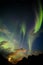 Aurora Borealis dances over the risiing moon